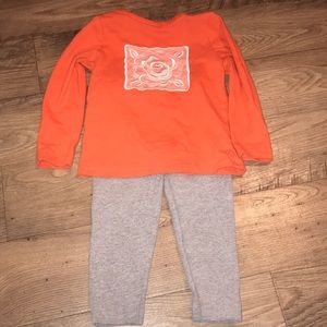 Orange shirt gray pants
